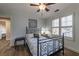 Bedroom featuring wood floors, a patterned bedspread, and two shuttered windows at 2075 Crabapple Parc Way, Roswell, GA 30076