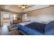 Primary bedroom features a bed, wood flooring, ceiling fan, and access to the bathroom at 2075 Crabapple Parc Way, Roswell, GA 30076