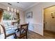 Cozy dining room with a glass table, four chairs, and sliding glass doors at 2075 Crabapple Parc Way, Roswell, GA 30076