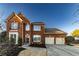 Traditional two-story brick home with a manicured lawn, attached garage, and mature landscaping at 2075 Crabapple Parc Way, Roswell, GA 30076
