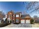 Charming brick home with a two-car garage, manicured landscaping, and a welcoming front entrance at 2075 Crabapple Parc Way, Roswell, GA 30076