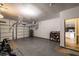 Clean, well-lit garage with a peek into the home featuring hardwood floors and kitchen cabinets at 2075 Crabapple Parc Way, Roswell, GA 30076