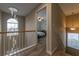 Hallway that leads to a sunlit bedroom with wood floors and neutral paint at 2075 Crabapple Parc Way, Roswell, GA 30076