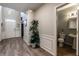 View of the hall that connects to a bathroom, features include hardwood floors and white wall trim at 2075 Crabapple Parc Way, Roswell, GA 30076