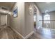 Hallway features wood flooring and an arched window with chandelier in the background at 2075 Crabapple Parc Way, Roswell, GA 30076