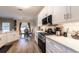 Bright kitchen featuring stainless appliances, white cabinets and island open to dining room at 2075 Crabapple Parc Way, Roswell, GA 30076