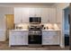 Modern kitchen with white cabinets, stainless steel appliances, and quartz countertops at 2075 Crabapple Parc Way, Roswell, GA 30076