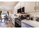 Updated kitchen featuring stainless appliances, white cabinets, and a view into dining area at 2075 Crabapple Parc Way, Roswell, GA 30076