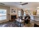 Comfortable living room features a fireplace, hardwood floors, and a seamless connection to the dining area at 2075 Crabapple Parc Way, Roswell, GA 30076