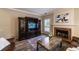 Relaxing living room boasts hardwood floors, a fireplace, and a view of the entertainment center at 2075 Crabapple Parc Way, Roswell, GA 30076