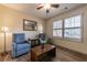 Cozy sitting area with natural light, wood flooring and comfortable blue seating, perfect for relaxation at 2075 Crabapple Parc Way, Roswell, GA 30076