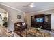 Inviting living room with hardwood floors, a ceiling fan, and a large entertainment center at 2075 Crabapple Parc Way, Roswell, GA 30076