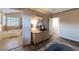 Primary bedroom showing access to a bathroom with a tub, dresser, and wood flooring at 2075 Crabapple Parc Way, Roswell, GA 30076