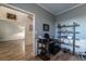 Office area with neutral walls and hardwood floors that connects to another room, also includes a black office shelf at 2075 Crabapple Parc Way, Roswell, GA 30076