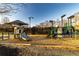 A community playground with slides and climbing structures and nearby benches provides a safe and fun environment for children at 2075 Crabapple Parc Way, Roswell, GA 30076