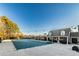 Large community pool with a protective cover, surrounded by mature trees and lounge areas at 2075 Crabapple Parc Way, Roswell, GA 30076