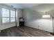 Image of an empty room, featuring hardwood floors, a lamp, and a window with blinds at 2075 Crabapple Parc Way, Roswell, GA 30076