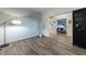 Image of an empty room that connects to the hallway and an office, featuring hardwood floors and a lamp in the corner at 2075 Crabapple Parc Way, Roswell, GA 30076