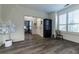 Image of an empty room that connects to the hallway and an office, featuring hardwood floors and a lamp in the corner at 2075 Crabapple Parc Way, Roswell, GA 30076