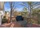 Wood deck with seating, a grill, and views of trees and the wooded backyard at 239 Taylors Farm Dr, Canton, GA 30115