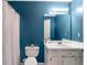 Bathroom with blue walls, white cabinets, and standard fixtures at 239 Taylors Farm Dr, Canton, GA 30115