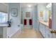 Bright bathroom featuring a soaking tub, separate shower, and a double vanity at 239 Taylors Farm Dr, Canton, GA 30115