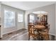 Bright dining nook featuring wood-look floors and a view into a traditional-style dining room at 239 Taylors Farm Dr, Canton, GA 30115