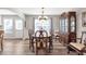Spacious dining area with a large wooden dining table and elegant china cabinet at 239 Taylors Farm Dr, Canton, GA 30115