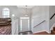 Welcoming foyer with hardwood floors, staircase, and natural light at 239 Taylors Farm Dr, Canton, GA 30115