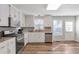 Updated kitchen with stainless steel appliances, white cabinets and hardwood floors at 239 Taylors Farm Dr, Canton, GA 30115