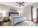 Serene bedroom features a plush bed, ceiling fan, and ample natural light at 239 Taylors Farm Dr, Canton, GA 30115