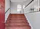 Carpeted staircase leading to the upper level, enhancing the home's classic charm at 239 Taylors Farm Dr, Canton, GA 30115