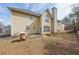 Backyard view of two-story house with a patio and small garden beds at 349 Azalea Chase Dr, Suwanee, GA 30024