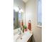 A bathroom with a vanity, a sink, and a window with blinds for natural light at 349 Azalea Chase Dr, Suwanee, GA 30024