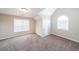 Bedroom with an arched window, neutral walls and carpeted flooring at 349 Azalea Chase Dr, Suwanee, GA 30024