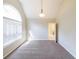 Bedroom with arched window, neutral walls, brown carpet and a pendant light fixture at 349 Azalea Chase Dr, Suwanee, GA 30024