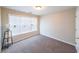 Bedroom with a large window that allows natural light and neutral carpet flooring at 349 Azalea Chase Dr, Suwanee, GA 30024