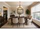 Elegant dining room features a chandelier, large window and a neutral color palette at 349 Azalea Chase Dr, Suwanee, GA 30024