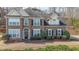 Attractive brick home featuring a symmetrical design, a well-kept lawn, and lush landscaping for great curb appeal at 349 Azalea Chase Dr, Suwanee, GA 30024