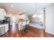 Open kitchen view featuring a granite breakfast bar with seating and hardwood flooring at 349 Azalea Chase Dr, Suwanee, GA 30024