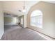 Bright living room featuring a fireplace, vaulted ceilings, recessed lighting and a large arched window at 349 Azalea Chase Dr, Suwanee, GA 30024