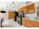 Bright kitchen features tile floors, black appliances, and wooden cabinets at 815 Riverstone Ln, Woodstock, GA 30188