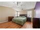 Spacious main bedroom boasts wood floors, vaulted ceilings, and a ceiling fan at 815 Riverstone Ln, Woodstock, GA 30188