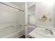 Bright bathroom features a shower-tub combination and white vanity at 858 Heritage Valley Rd, Norcross, GA 30093