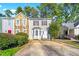 Charming two-story townhome featuring stone accents, bay window, and well-maintained landscaping at 858 Heritage Valley Rd, Norcross, GA 30093
