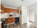 Neutral kitchen featuring wood cabinetry, black appliances, luxury vinyl plank flooring, and ample lighting at 858 Heritage Valley Rd, Norcross, GA 30093