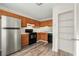 Functional kitchen featuring wooden cabinetry, stainless steel refrigerator, and modern appliances at 858 Heritage Valley Rd, Norcross, GA 30093