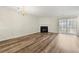 Spacious living room with fireplace, sliding glass door, and luxury vinyl plank flooring at 858 Heritage Valley Rd, Norcross, GA 30093