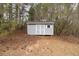 A standalone storage building for housing tools and equipment sits on a sloping piece of land at 2935 Pruitt Rd, Cumming, GA 30041