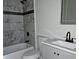 Bathroom featuring white marbled tile walls, and a shower over the tub at 6658 Collins Ct, Riverdale, GA 30274